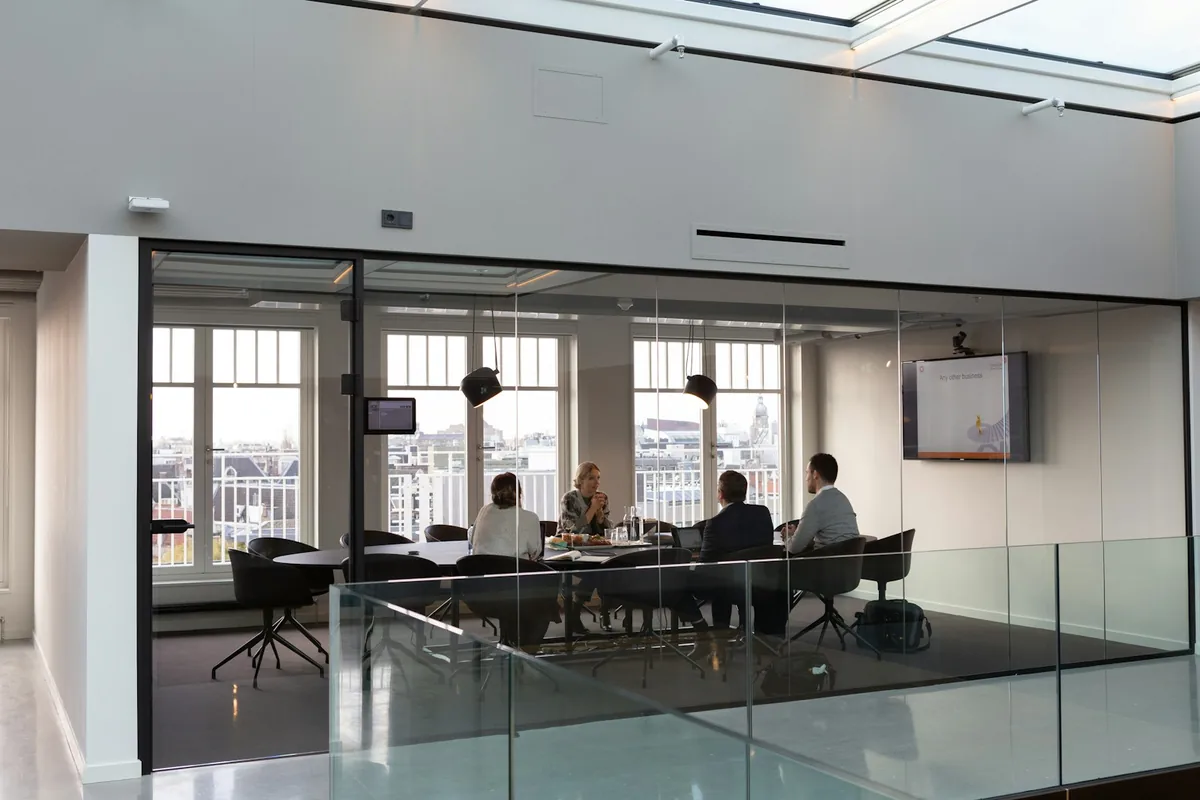 Colleagues collaborating around a table in a modern office