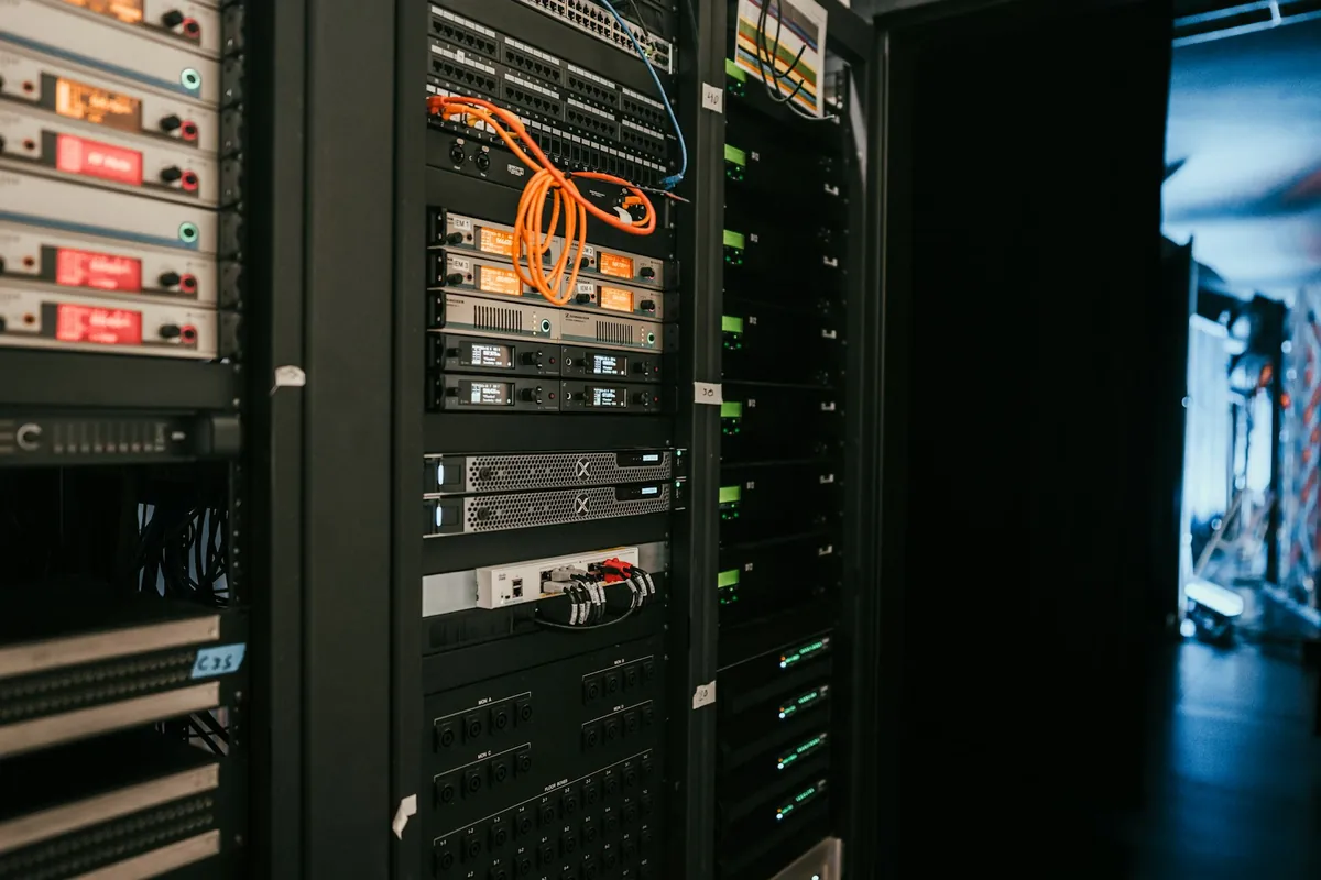 Illustrative stock photograph: Network and technology equipment racks in an equipment room.