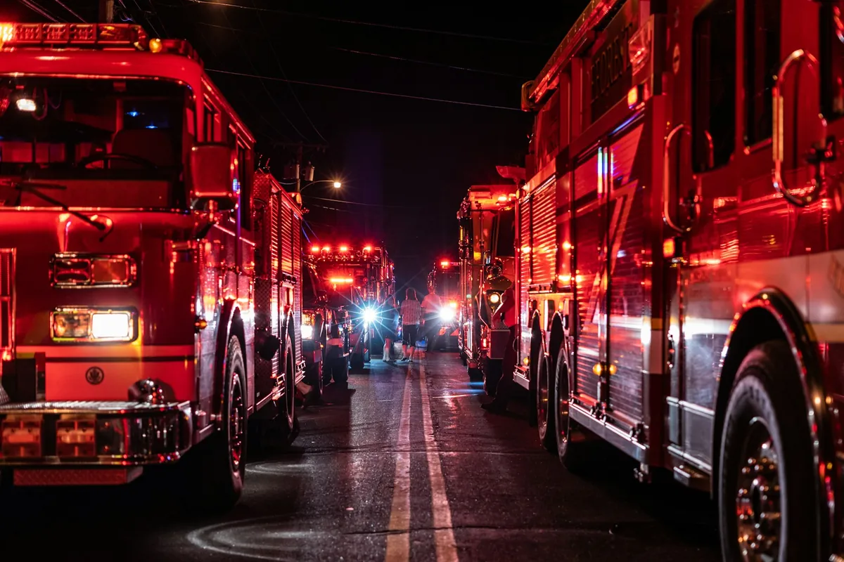 Fire service vehicles with emergency lights at night