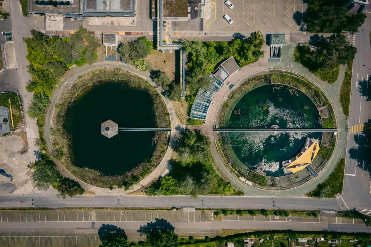 Aerial view of circular water treatment basins and utility pipework